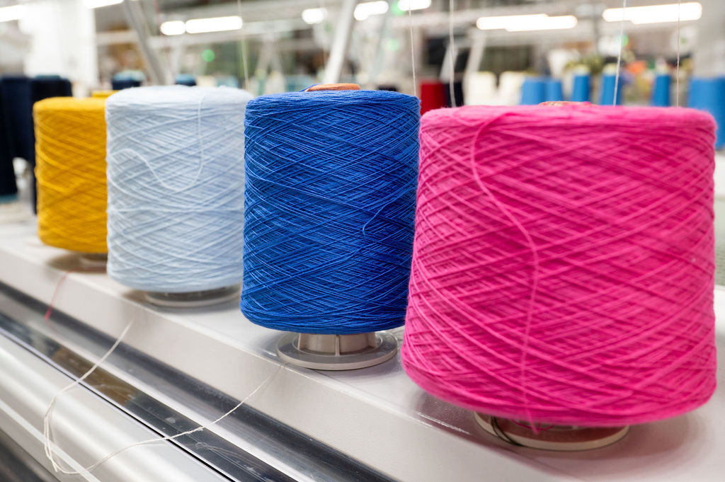 colorful spools of yarn on a production line