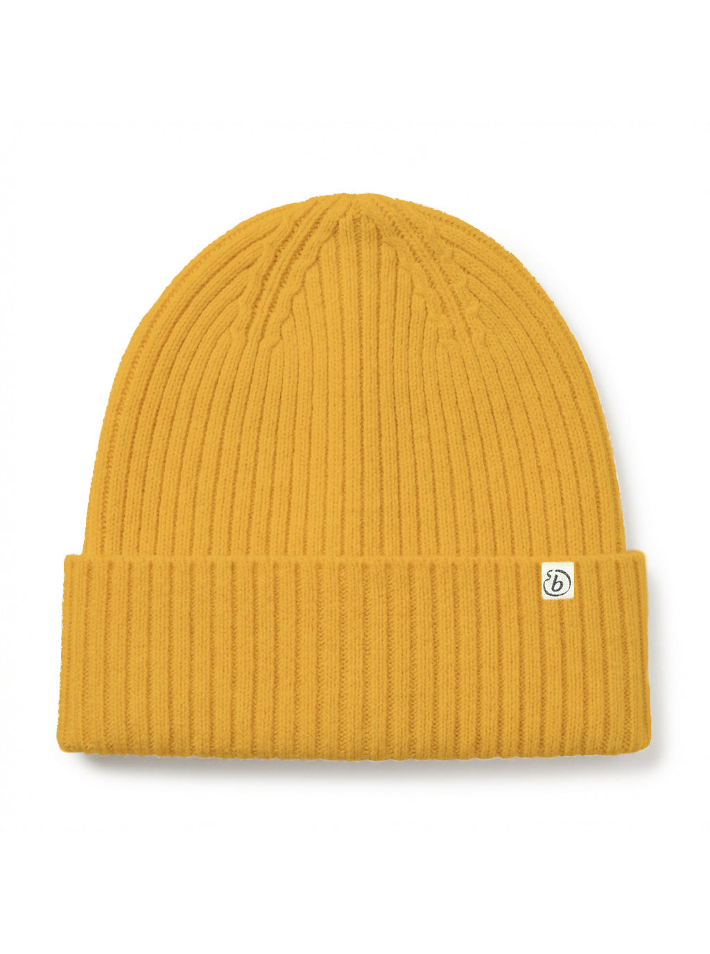 A ribbed knit beanie hat in a mustard yellow color, featuring a small white square logo patch on the folded cuff, set against a plain white background.