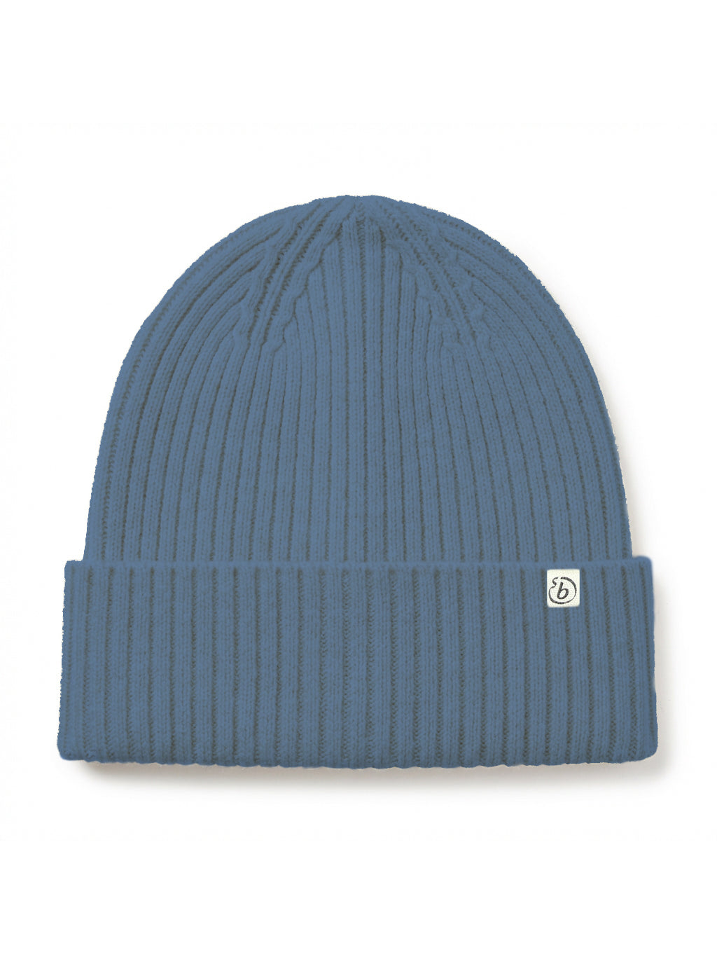 A ribbed knit beanie hat in a muted slate blue color, featuring a small circular white brand patch on the folded cuff, set against a plain white background.