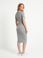 Woman wearing a gray ribbed dress on a white background